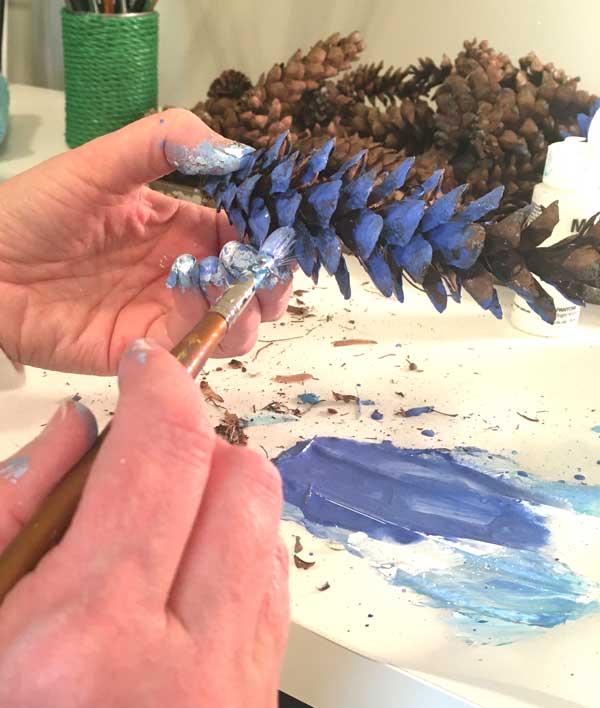 blue painted pine cones